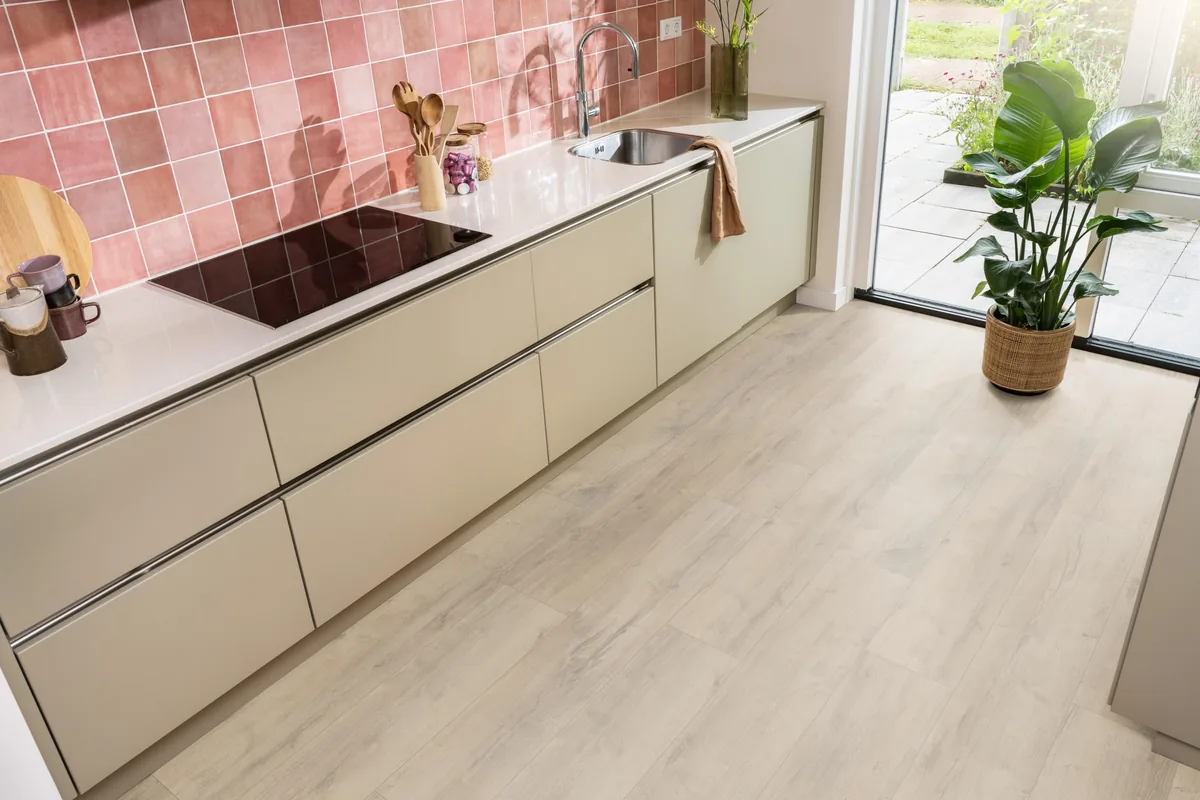 Sunnyside / Superior oak beige eiken, laminaat in een keuken met roze tegelwand en openslaande tuindeuren