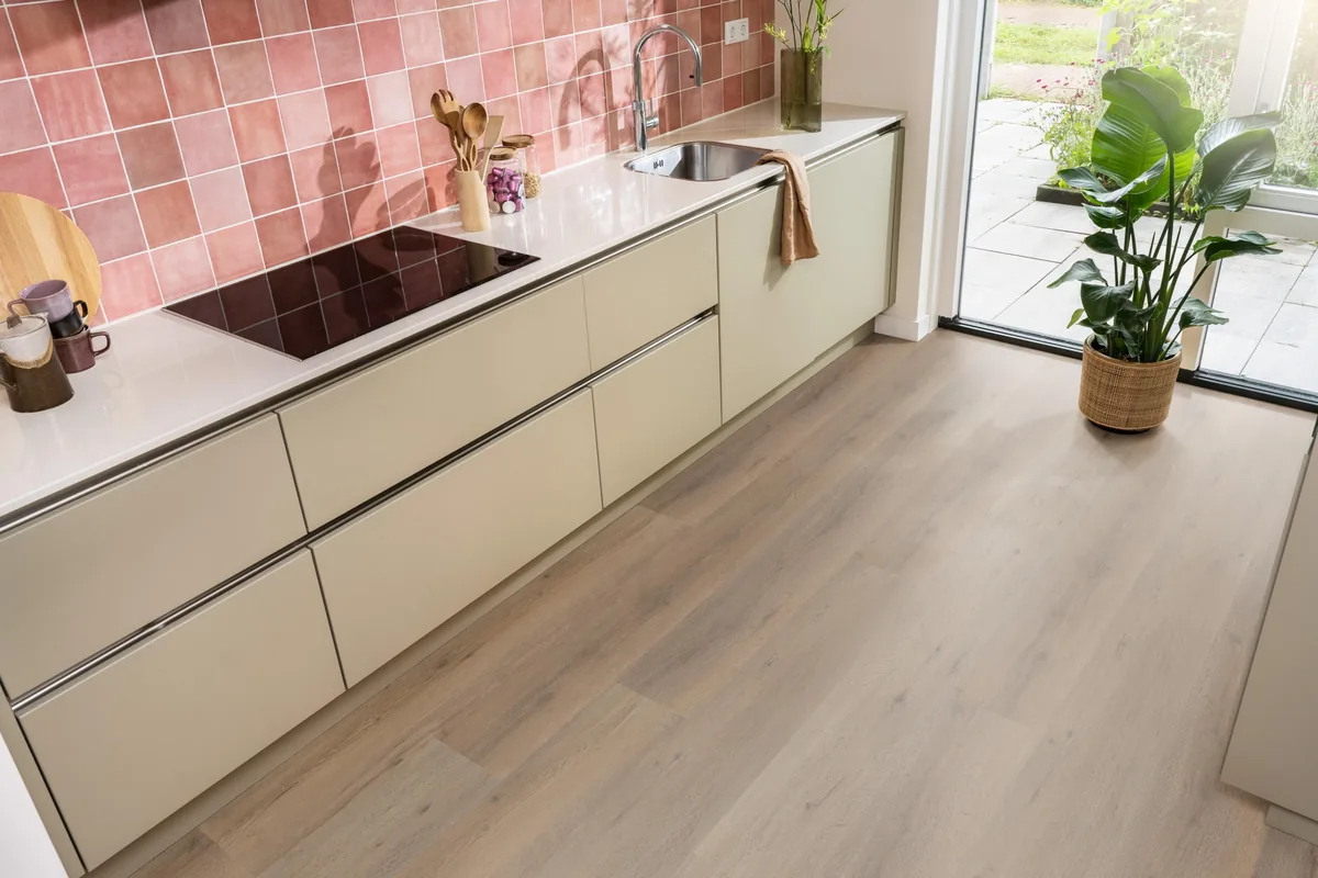Leyton / Vivero smoky, klik pvc in een keuken met een roze tegelwand en openslaande tuindeuren
