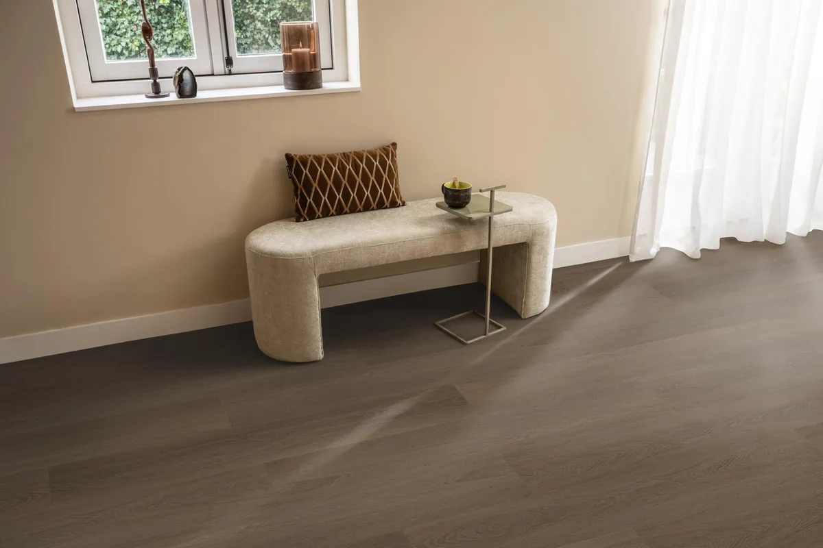 Fulham / Estino brown, plak pvc in een hal, met een bankje onder het raam en zonlicht over de vloer