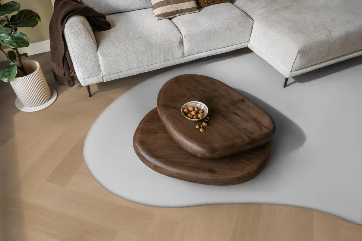 Fulham / Estino Dark oak, visgraat klik pvc in een woonkamer, met een lichte hoekbank en een wit vloerkleed
