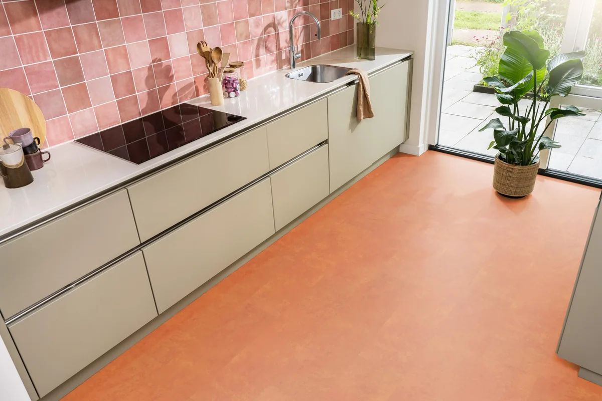 Finsbury / Viretto Orange, plak pvc in een keuken met een roze tegelwand en openslaande tuindeuren