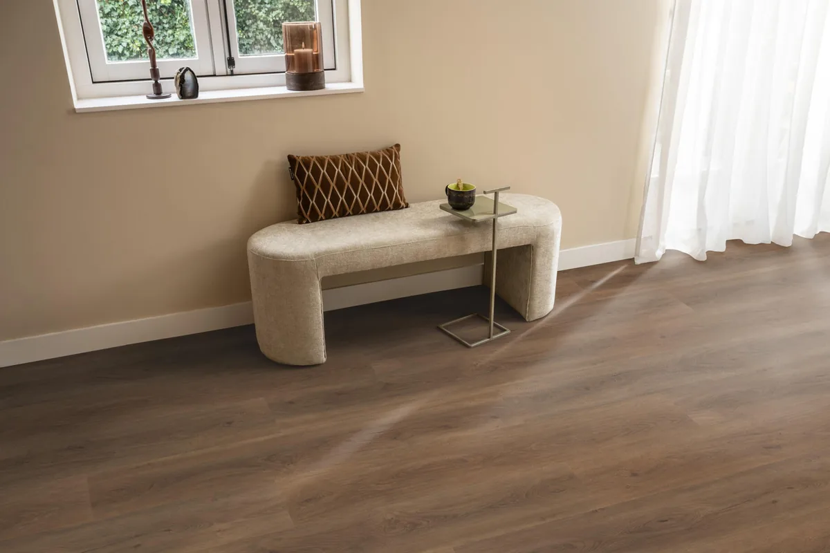 Parramatta / Robusto warm brown, plak pvc in een hal, met een bankje onder het raam en zonlicht over de vloer